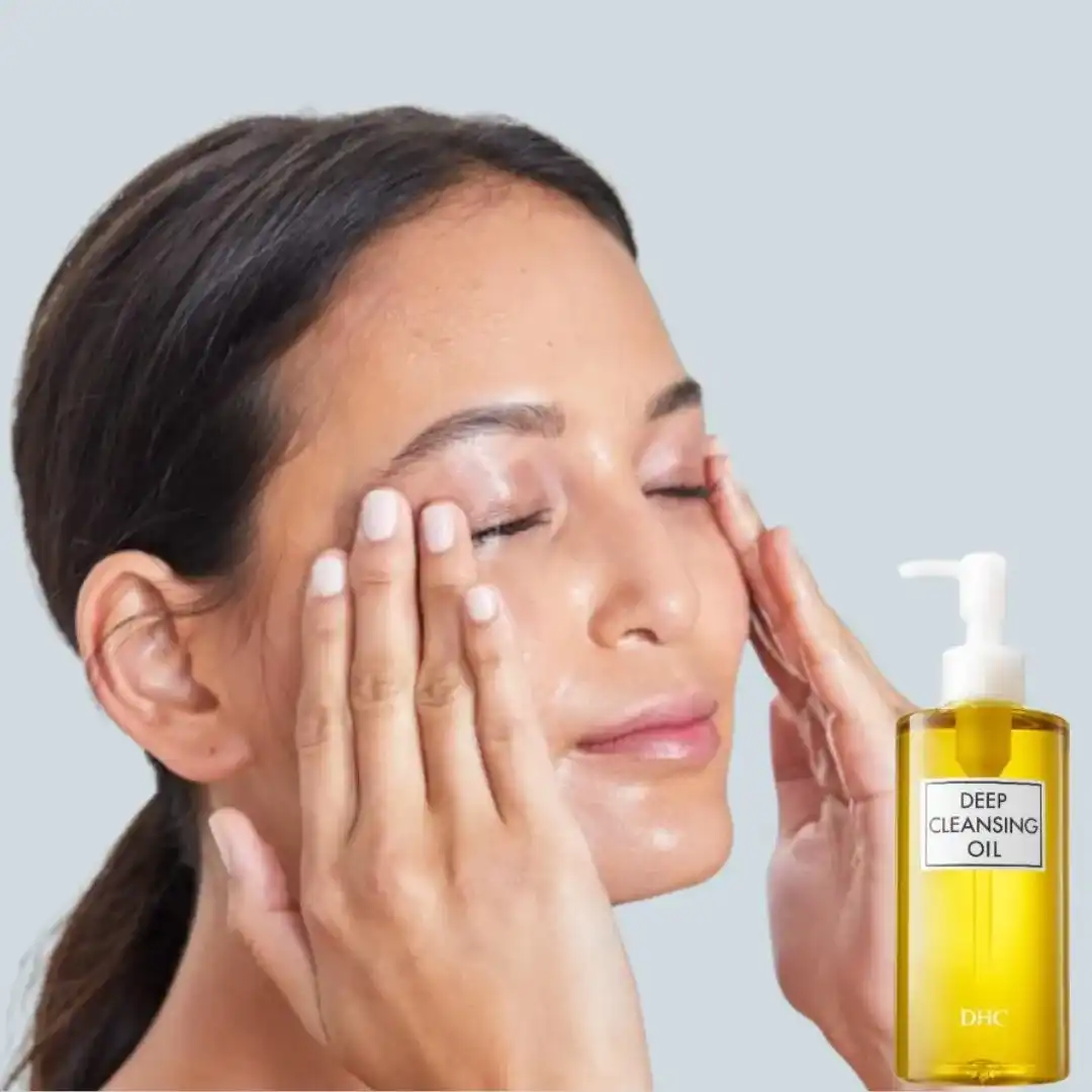 DHC Cleansing Oil bottle on a bathroom counter with soft lighting and skincare items