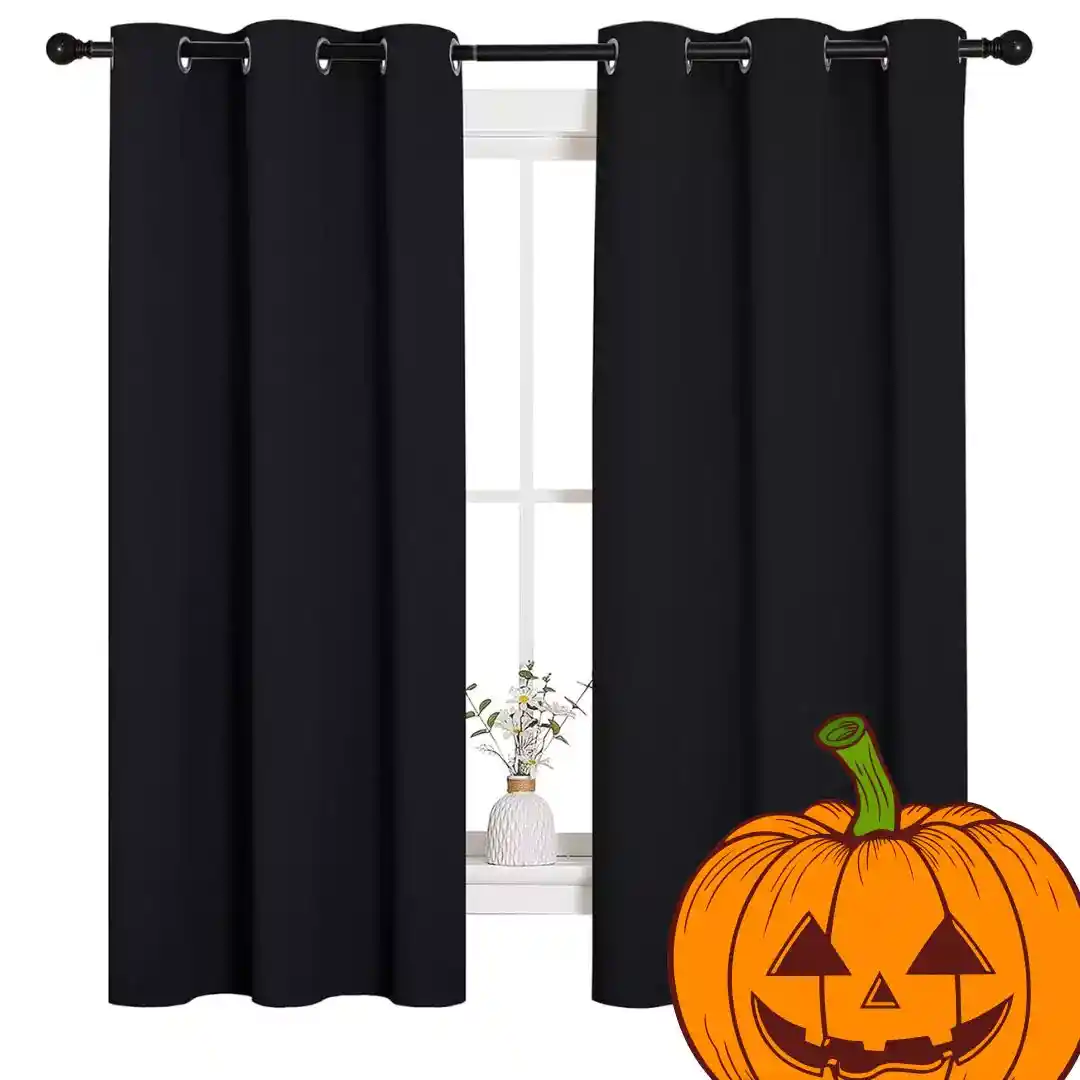 NICETOWN Halloween Pitch Black solid thermal insulated grommet blackout curtains hanging in a modern bedroom setting